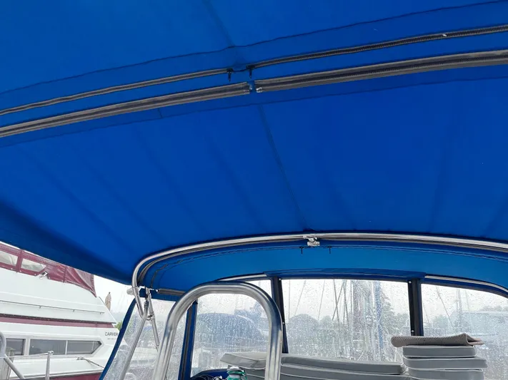 Amadeus Yacht Photos Pics Blue canopy of a 2014 Catalina 355 sailboat, with visible metal frame and windows.