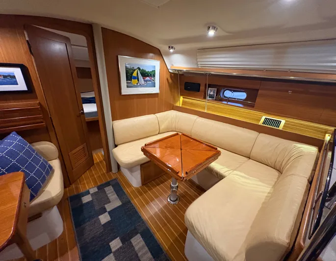 Amadeus Yacht Photos Pics Luxurious interior of 2014 Catalina 355 sailboat with cozy seating and elegant wood finishes.