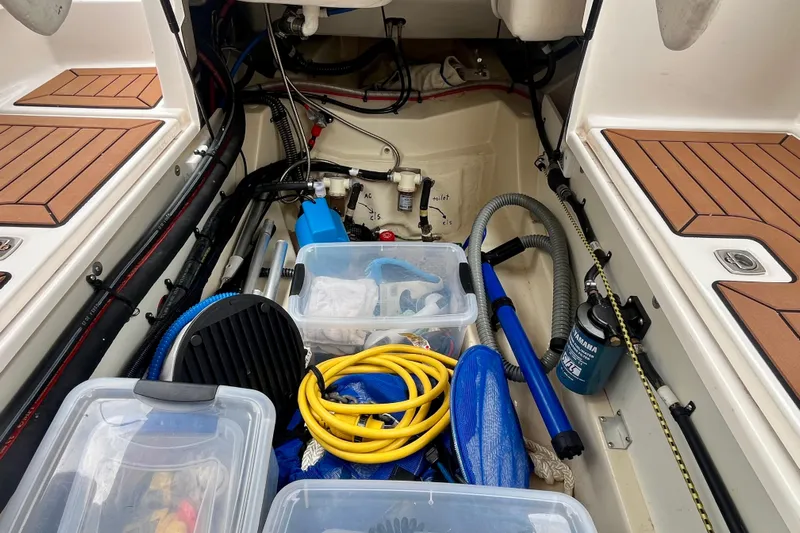  Yacht Photos Pics Storage compartment of 2023 Ranger Tugs R-27 boat with various equipment and supplies.