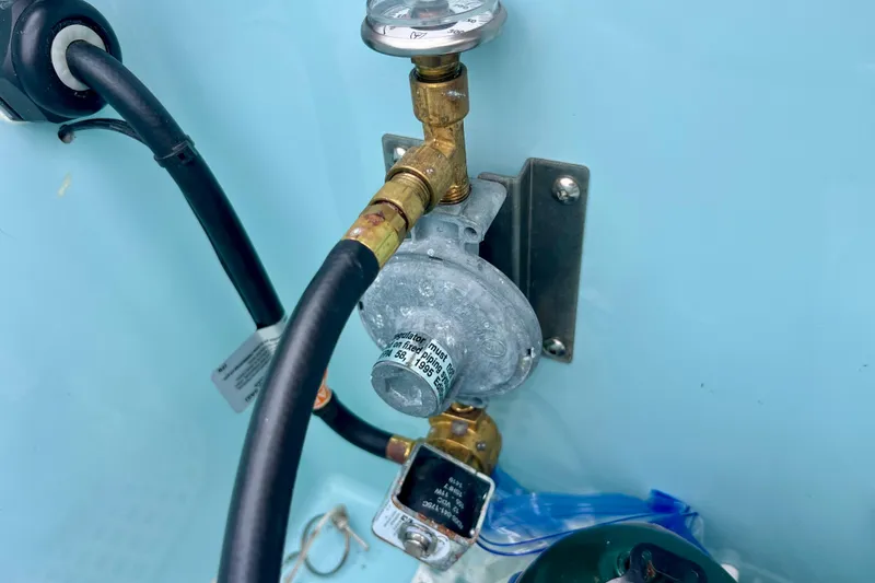  Yacht Photos Pics Close-up of a 2023 Ranger Tugs R-27 boat's gas regulator and hose connections.