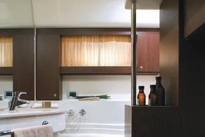  Yacht Photos Pics Luxurious bathroom interior of 2007 Ferretti Yachts 591 with elegant wood accents.