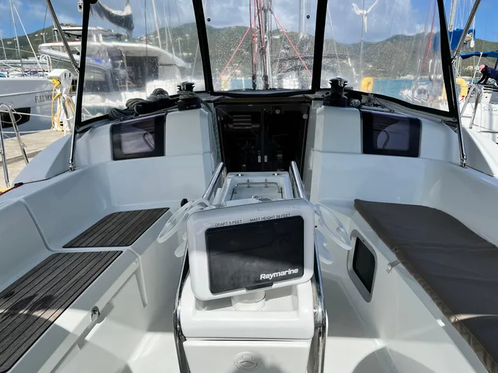 Reaching Heaven Yacht Photos Pics 2019 Jeanneau Sun Odyssey 389 cockpit with Raymarine navigation system, docked at marina.