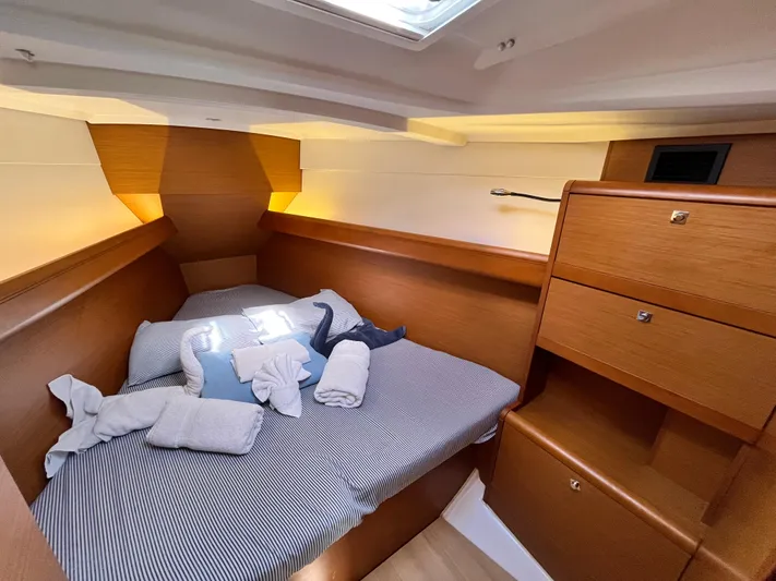 Reaching Heaven Yacht Photos Pics Cozy cabin interior of 2019 Jeanneau Sun Odyssey 389 sailboat with neatly arranged bedding.