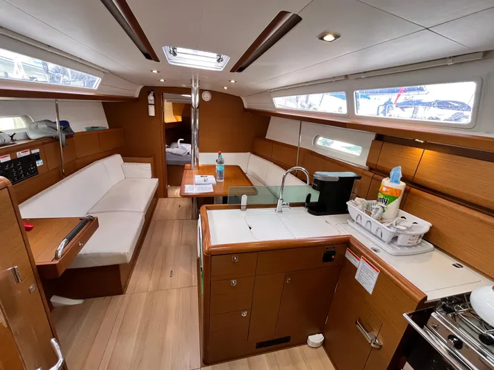 Reaching Heaven Yacht Photos Pics 2019 Jeanneau Sun Odyssey 389 interior with modern kitchen, seating, and natural light.