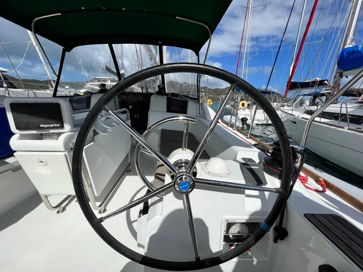 Reaching Heaven Yacht Photos Pics 2019 Jeanneau Sun Odyssey 389 yacht cockpit with steering wheel and navigation equipment.