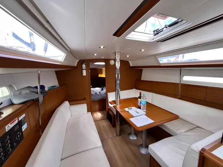 Reaching Heaven Yacht Photos Pics Interior of 2019 Jeanneau Sun Odyssey 389 yacht with cozy seating and dining area.