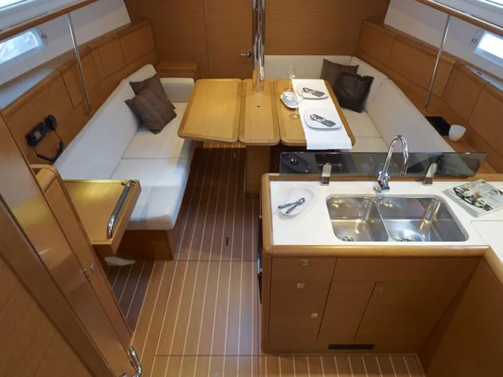 Reaching Heaven Yacht Photos Pics Interior of 2019 Jeanneau Sun Odyssey 389 yacht with modern kitchen and dining area.