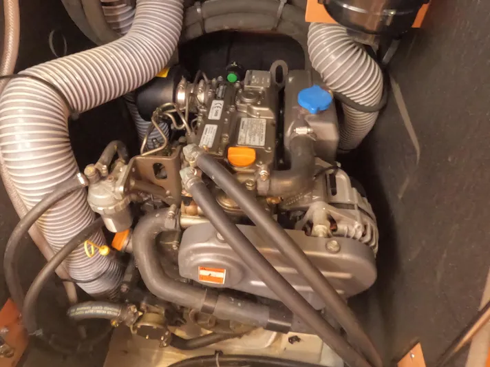 Reaching Heaven Yacht Photos Pics Engine compartment of a 2019 Jeanneau Sun Odyssey 389 sailboat, featuring hoses and mechanical components.