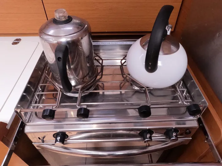 Reaching Heaven Yacht Photos Pics Stainless steel stove with kettles in Jeanneau Sun Odyssey 389 yacht kitchen, 2019 model.