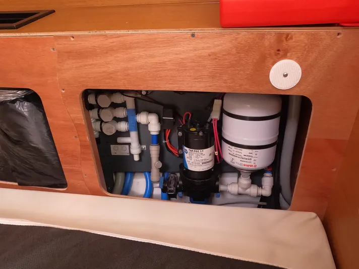 Reaching Heaven Yacht Photos Pics Plumbing system inside 2019 Jeanneau Sun Odyssey 389 yacht, featuring pipes and pump components.