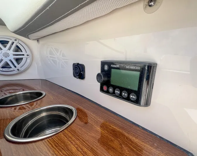  Yacht Photos Pics 2023 Tiara Yachts 38 LS interior with Fusion stereo and cup holders.