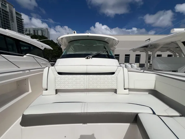  Yacht Photos Pics 2023 Tiara Yachts 38 LS boat interior with white seating under a blue sky.