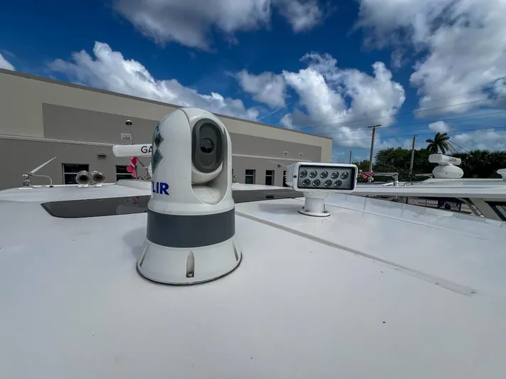  Yacht Photos Pics 2023 Tiara Yachts 38 LS with advanced navigation equipment under a partly cloudy sky.