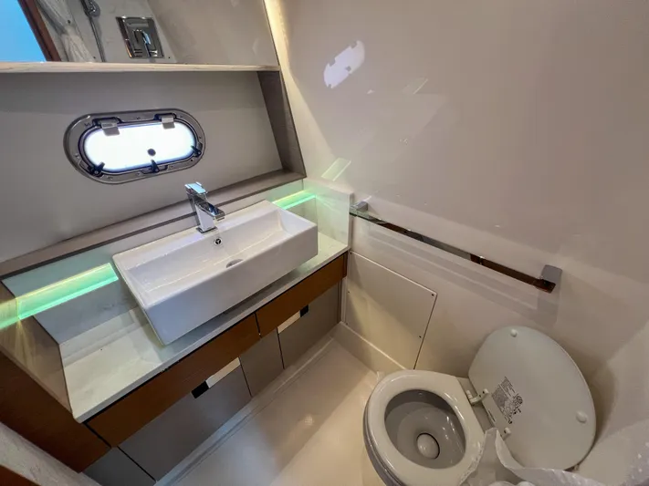  Yacht Photos Pics 2023 Tiara Yachts 38 LS bathroom with modern sink and toilet.