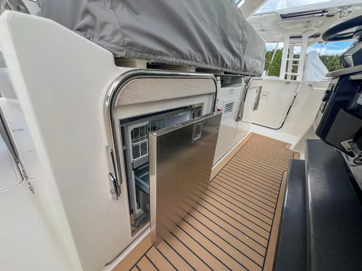  Yacht Photos Pics 2023 Tiara Yachts 38 LS interior with open stainless steel drawer on teak flooring.