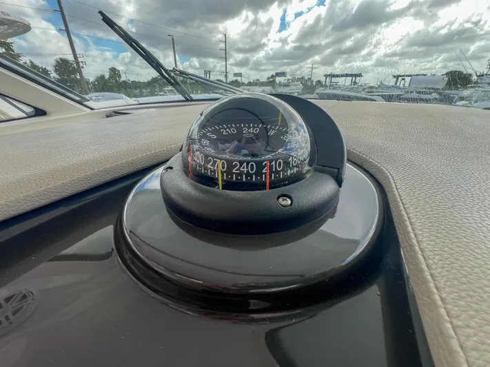  Yacht Photos Pics Compass on 2023 Tiara Yachts 38 LS dashboard under cloudy sky.
