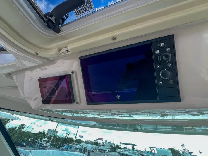  Yacht Photos Pics Control panel of 2023 Tiara Yachts 38 LS with digital displays and buttons.