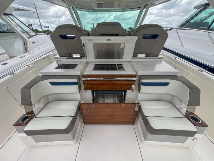  Yacht Photos Pics 2023 Tiara Yachts 38 LS interior with seating and kitchenette, featuring modern design elements.