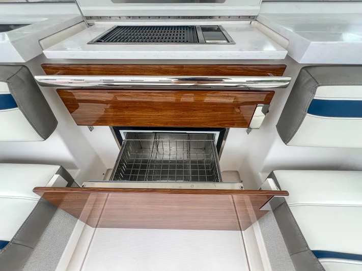  Yacht Photos Pics 2023 Tiara Yachts 38 LS interior with open wooden cabinetry and modern appliances.