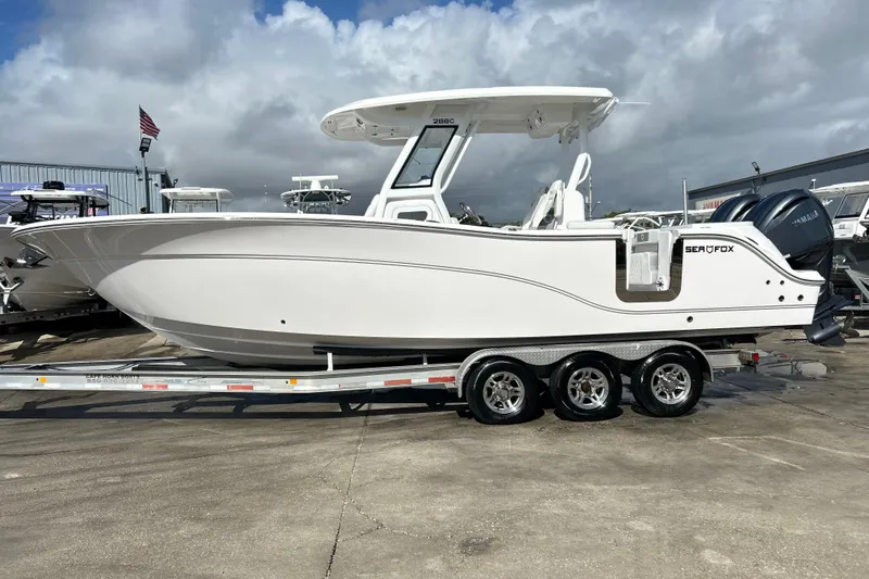  Yacht Photos Pics 2026 Sea Fox 288 Commander boat on trailer, displayed outdoors under cloudy sky.