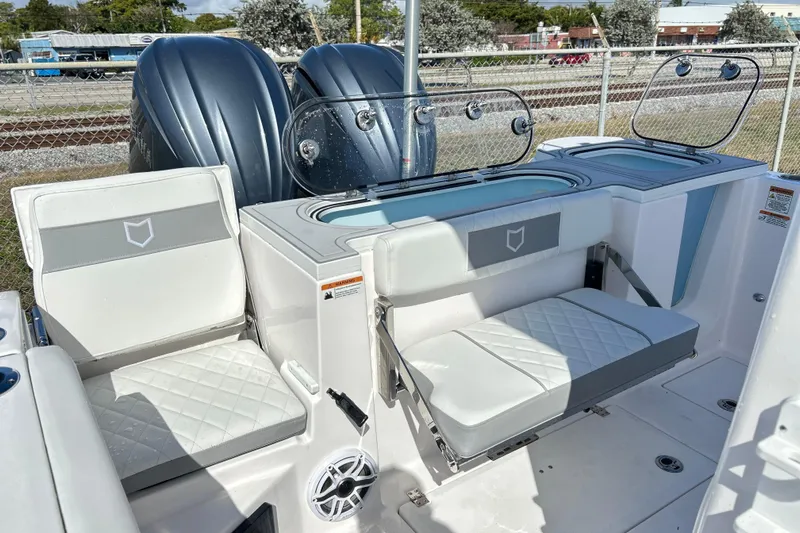  Yacht Photos Pics 2026 Sea Fox 288 Commander boat interior with cushioned seating and dual outboard motors.