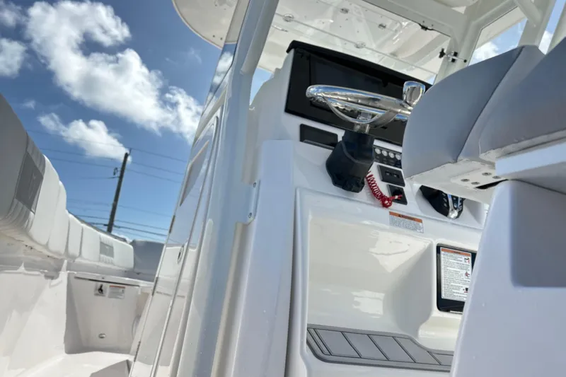  Yacht Photos Pics 2026 Sea Fox 288 Commander boat interior with steering wheel, under a clear blue sky.