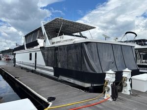 1997 Sumerset 16x83 houseboat docked under cloudy sky.