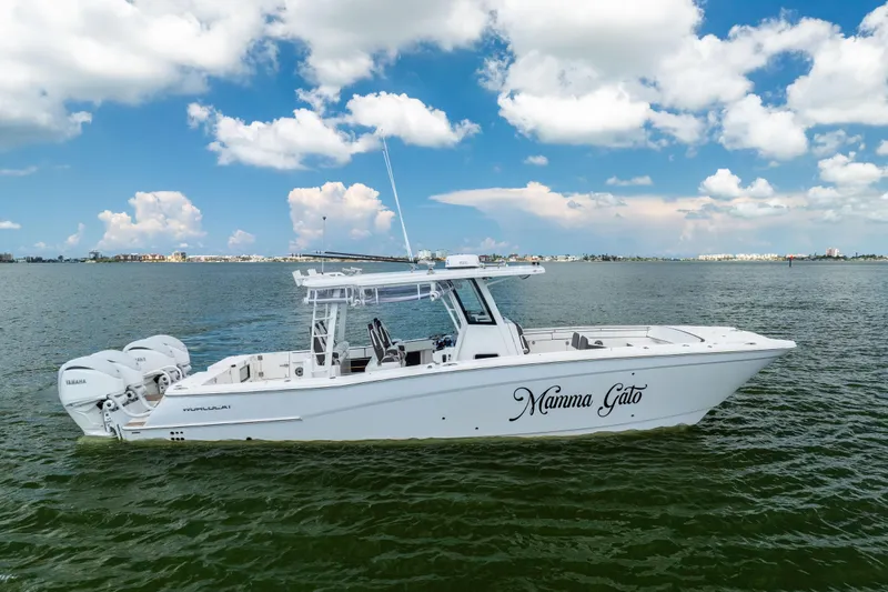 Mama Gato Yacht Photos Pics 2022 World Cat 400 CC-X boat on water, clear sky background.