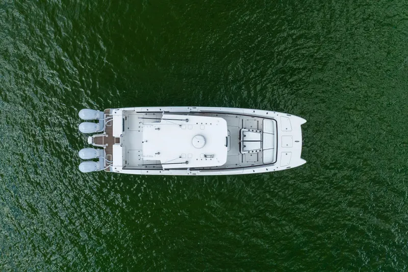 Mama Gato Yacht Photos Pics Aerial view of 2022 World Cat 400 CC-X boat on green water.