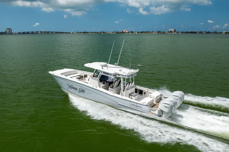Mama Gato Yacht Photos Pics 2022 World Cat 400 CC-X boat cruising on green water under a blue sky.