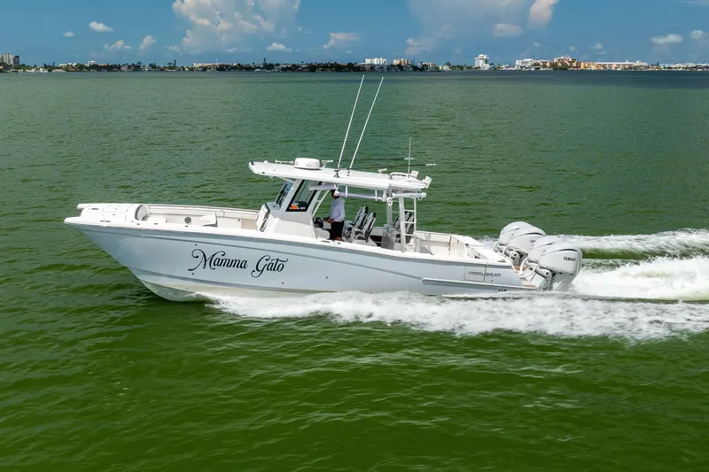 Mama Gato Yacht Photos Pics 2022 World Cat 400 CC-X boat cruising on green water under a blue sky.