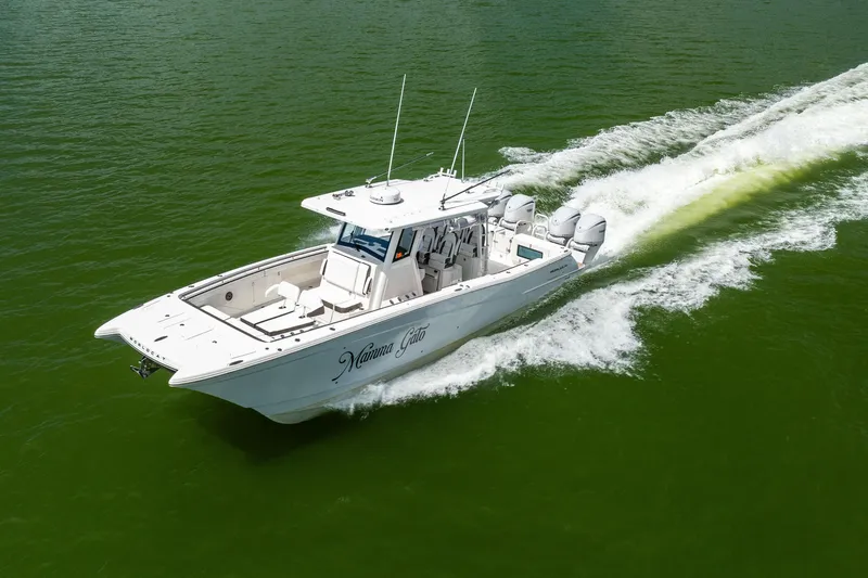 Mama Gato Yacht Photos Pics 2022 World Cat 400 CC-X boat cruising on green water, showcasing sleek design and powerful engines.
