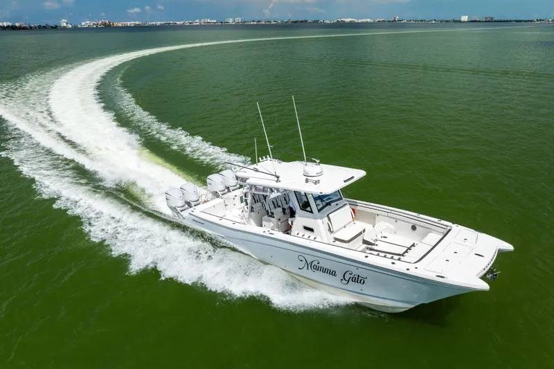 Mama Gato Yacht Photos Pics 2022 World Cat 400 CC-X boat cruising on green water, leaving a wake trail.