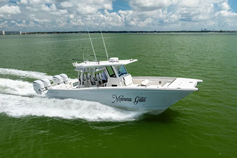 Mama Gato Yacht Photos Pics 2022 World Cat 400 CC-X boat cruising on green water under a cloudy sky.