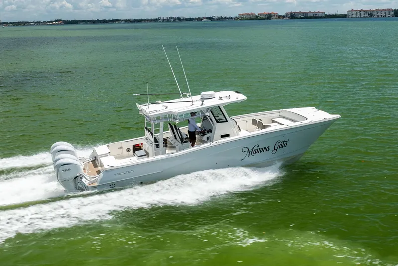 Mama Gato Yacht Photos Pics 2022 World Cat 400 CC-X boat cruising on green water with triple Yamaha engines.