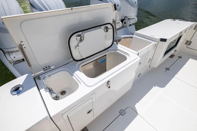 Mama Gato Yacht Photos Pics 2022 World Cat 400 CC-X boat with open storage compartments and sink on deck.