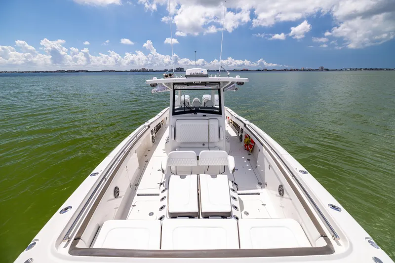 Mama Gato Yacht Photos Pics 2022 World Cat 400 CC-X boat on calm water under a partly cloudy sky.