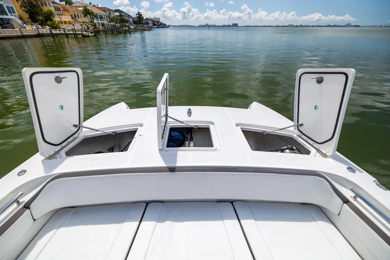 Mama Gato Yacht Photos Pics 2022 World Cat 400 CC-X boat with open storage compartments on calm water.