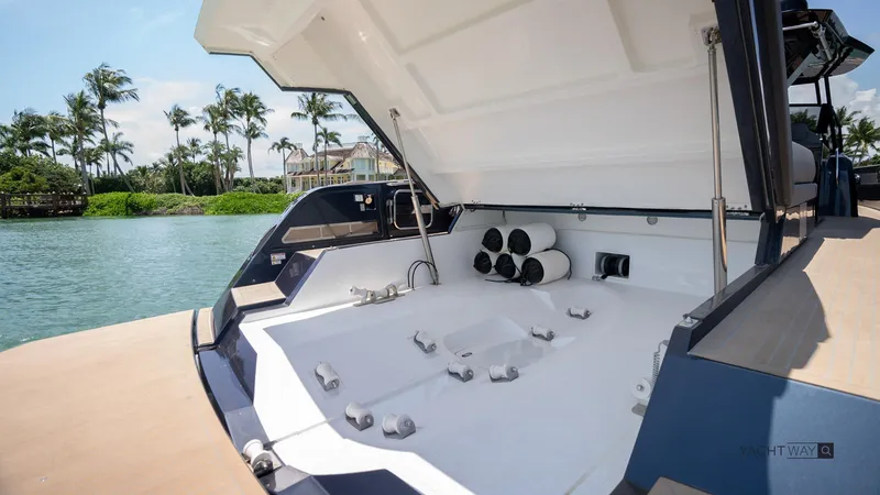 Available Now Yacht Photos Pics 2025 Pardo Yachts P50 open deck with storage, docked by tropical waterfront.