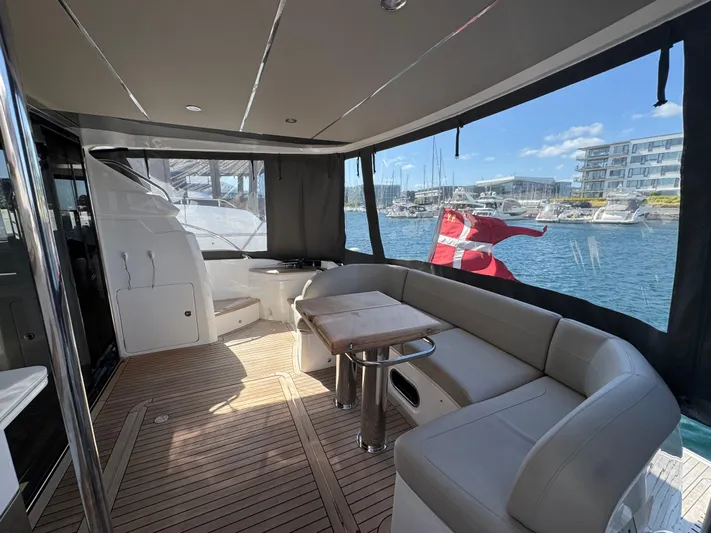  Yacht Photos Pics Luxurious 2020 Princess F55 yacht interior with seating, table, and scenic marina view.