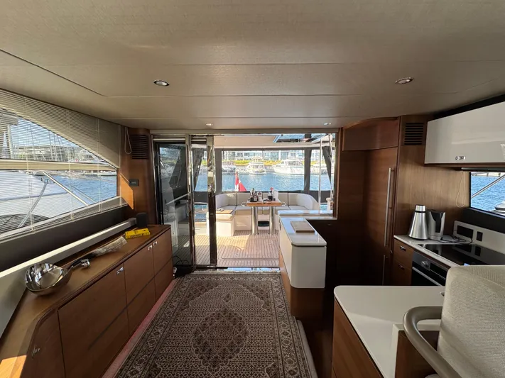  Yacht Photos Pics Luxurious interior of 2020 Princess F55 yacht with modern kitchen and elegant decor.