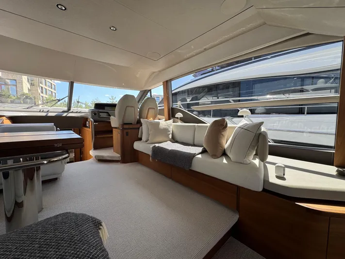  Yacht Photos Pics Luxurious interior of 2020 Princess F55 yacht with elegant seating and large windows.