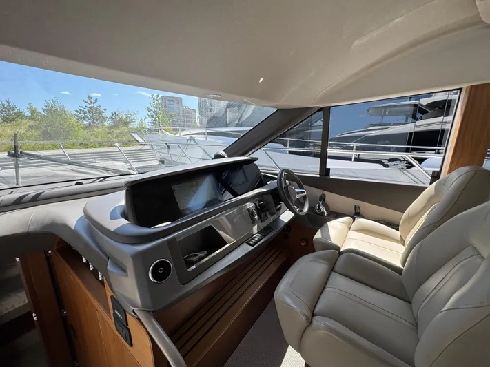  Yacht Photos Pics Luxurious 2020 Princess F55 yacht interior with modern helm and plush seating.