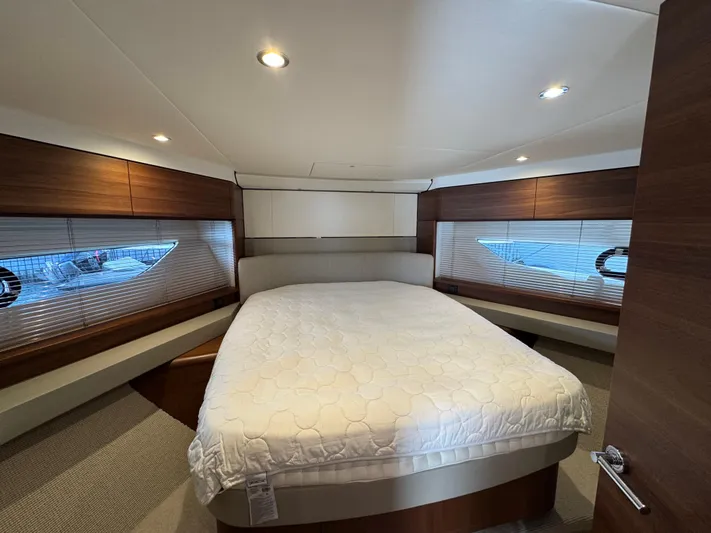  Yacht Photos Pics Luxurious bedroom interior of 2020 Princess F55 yacht with modern design and cozy bedding.