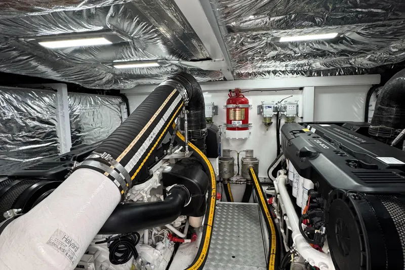  Yacht Photos Pics Engine room of a 2020 Princess F55 yacht, featuring modern equipment and insulation.
