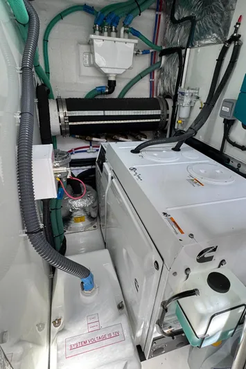  Yacht Photos Pics Engine room of 2020 Princess F55 yacht with mechanical components and wiring.