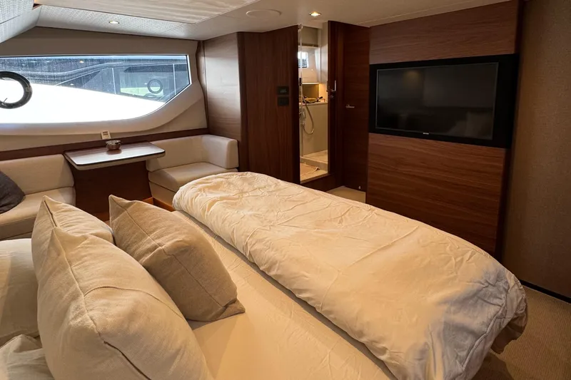  Yacht Photos Pics Luxurious 2020 Princess F55 yacht interior with cozy bedroom, modern decor, and large TV.