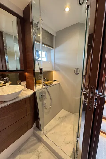 Yacht Photos Pics Luxurious bathroom in 2020 Princess F55 yacht with glass shower and modern fixtures.