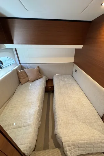  Yacht Photos Pics Interior of 2020 Princess F55 yacht with twin beds and wooden accents.