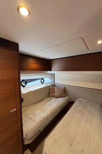  Yacht Photos Pics Luxurious cabin interior of 2020 Princess F55 yacht with twin beds and elegant wood finish.